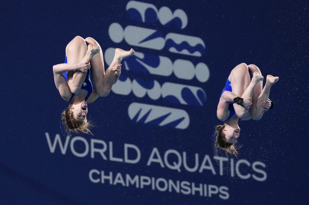 Qatar - Extra points for tongue tricks: Caeli Mckay and Kate Miller of Canada compete during the women's synchronized 10m platform diving final at the World Aquatics Championships in Doha, Qatar, Tuesday, Feb. 6, 2024.Photo: Hassan Ammar/AP