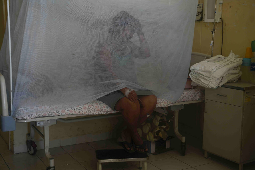 PERU — Fever from mosquitos creates emergency: Jenny Chiroque, suffering from dengue, sits on a bed with netting at La Merced Hospital in Paita, Peru, Thursday, Feb. 29, 2024. Peru declared a health emergency in most of its provinces on Feb. 26 due to a growing number of dengue cases.Photo: Martin Mejia/AP