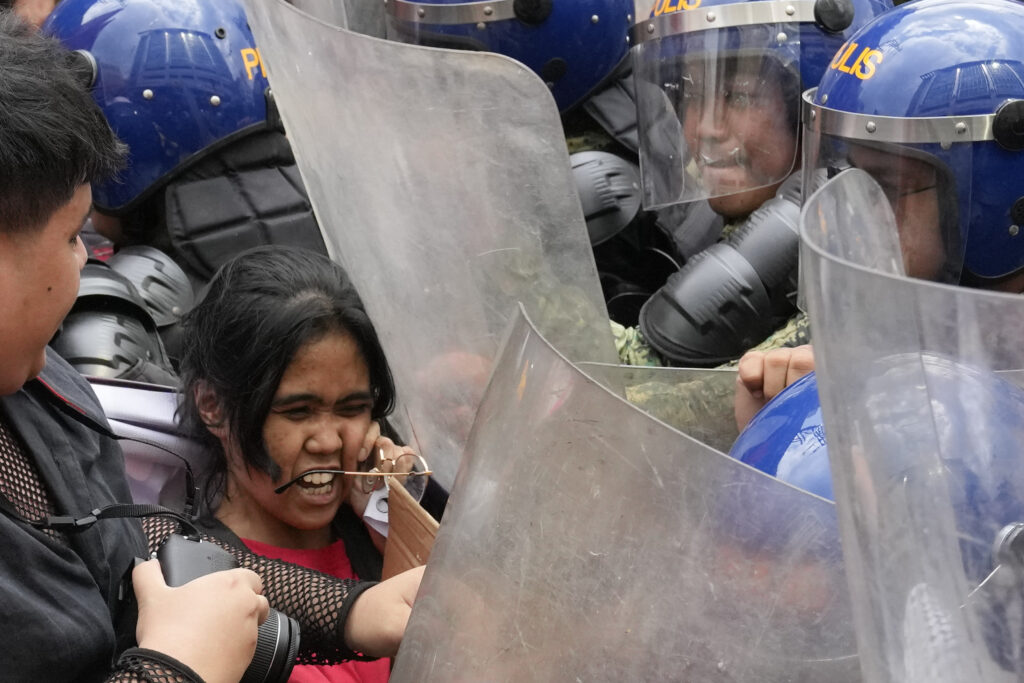 MANILA — Strong, passionate women fighting for their rights: Police push a woman activist as they try to march near the Malacanang presidential palace during an International Women's Day protest in Manila, Philippines, on Friday, March 8, 2024.Photo: Aaron Favila/AP
