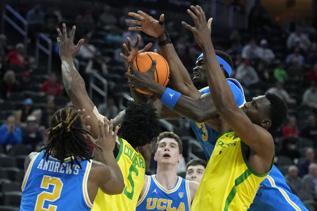 LAS VEGAS — ‘All hands on deck’ for a live ball: Oregon center N'Faly Dante, right, and UCLA forward Adem Bona (3) battle for a rebound during the second half of an NCAA college basketball game in the quarterfinal round of the Pac-12 tournament Thursday, March 14, 2024, in Las Vegas.Photo: John Locher/AP