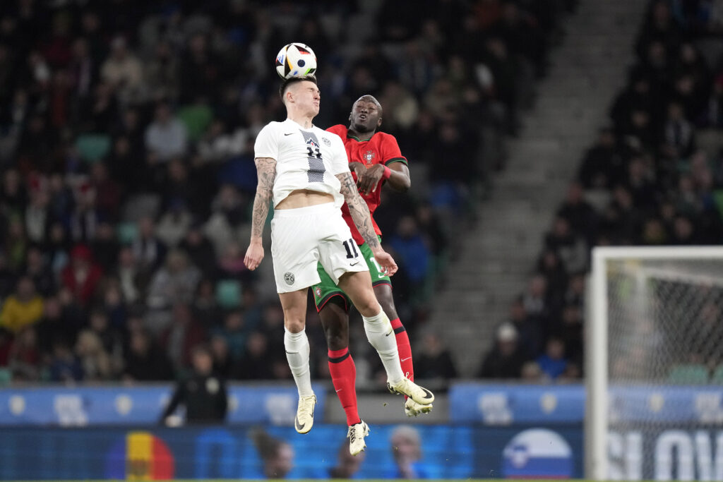 SLOVENIA — Impressive leaps to make ball contact: Slovenia's Benjamin Sesko, left, jumps for the ball with Portugal’s Danilo during the international friendly soccer match between Slovenia and Portugal at the Stozice stadium in Ljubljana, Slovenia, Tuesday, March 26, 2024.Photo: Darko Bandic/AP