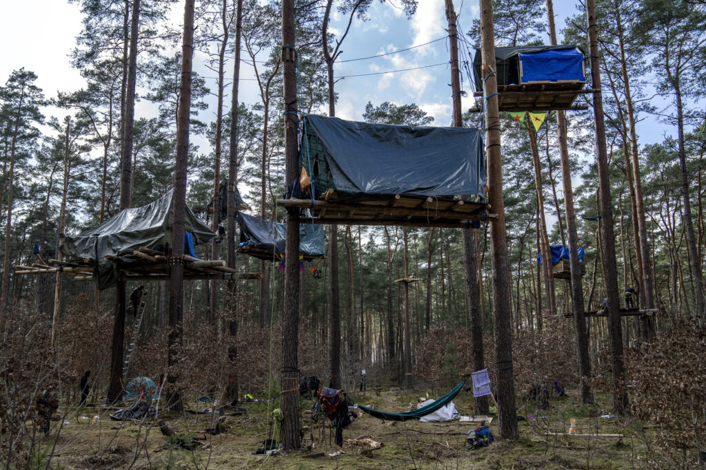 GERMANY — Infighting on the left: A view of tree houses set up by activists near the Tesla Gigafactory for electric cars in Gruenheide near Berlin, Germany, Tuesday, March 5, 2024. Production at Tesla's electric vehicle plant in Germany came to a standstill, and workers were evacuated after a power outage that officials suspect was caused by arson. The interior ministry in the state of Brandenburg says unidentified people are suspected of deliberately setting fire to a high-voltage transmission line on a power pylon.Photo: Ebrahim Noroozi/AP