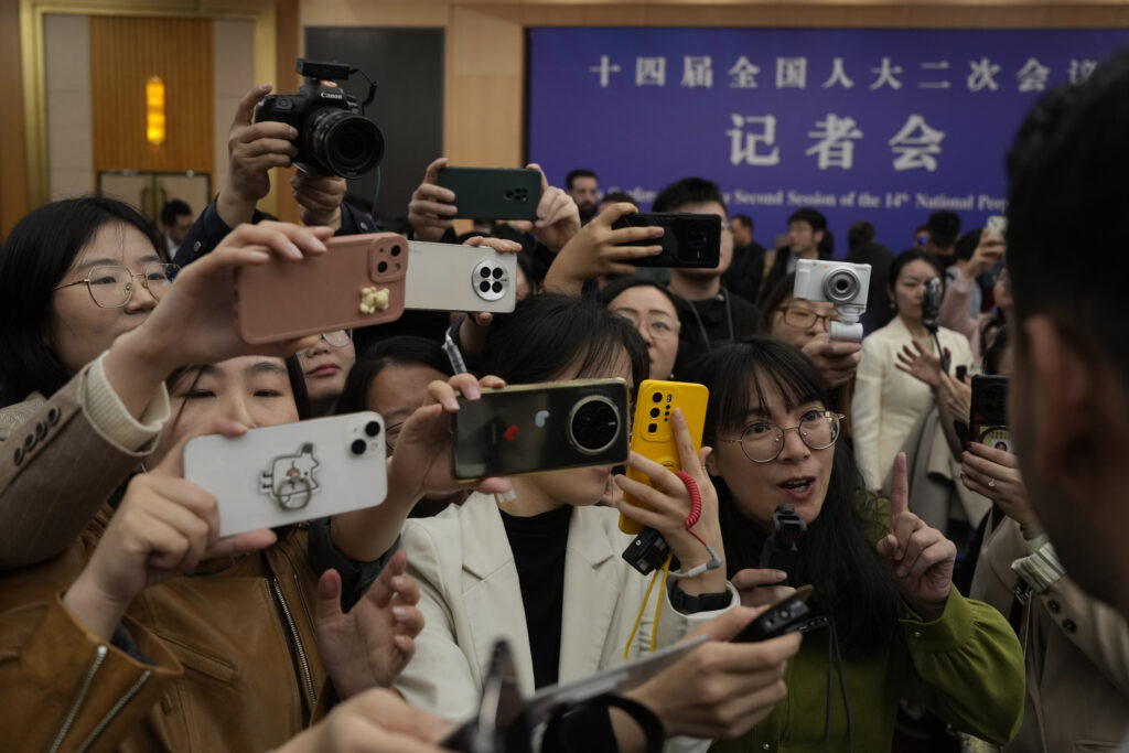 BEIJING — Iphones outnumber Nikons in new journalism: Chinese journalists mob a foreign journalist at the end of the Chinese Foreign Minister's press conference on the sideline of the National People's Congress in Beijing, Thursday, March 7, 2024.Photo: Ng Han Guan/AP