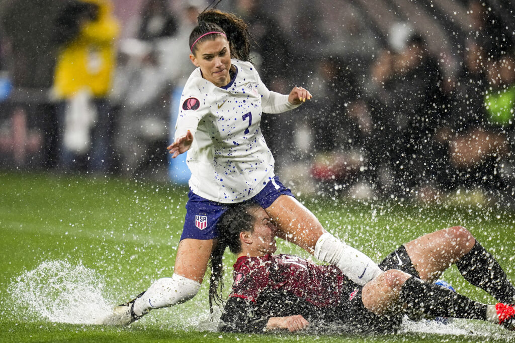 SAN DIEGO — When water gets in the way…: United States' Alex Morgan, above, collides with Canada's Vanessa Gilles during the first half of a CONCACAF Gold Cup women's soccer tournament semifinal match, Wednesday, March 6, 2024, in San Diego.Photo: Gregory Bull/AP