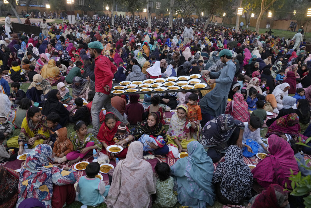 LAHORE — When breaking fast means community: Volunteers serve meals among families for breaking their fast during the Muslim's holy fasting month of Ramadan at a free meal distribution point run by a charity group in Lahore, Pakistan, Wednesday, March 13, 2024.Photo: K.M. Chaudary/AP