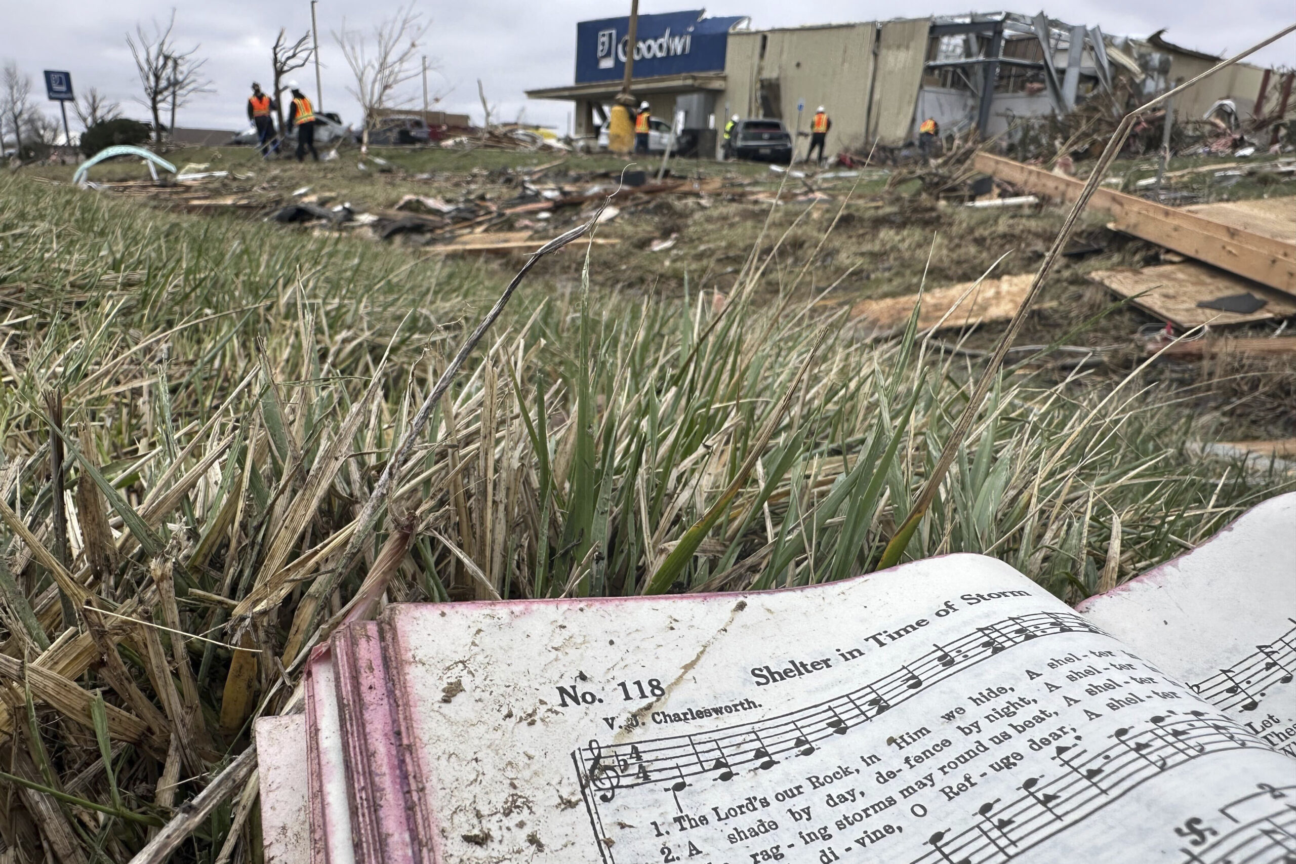 INDIANA — Nature’s revenge — in tornadoes … here a strewn hymnal was found open to “Shelter in Times of Storm”: A hymnal book from a destroyed church across the street is seen among the debris strewn in Winchester, IN, on Friday, March 15, 2024, after storms ripped through the area Thursday night.Photo: Isabella Volmert/AP