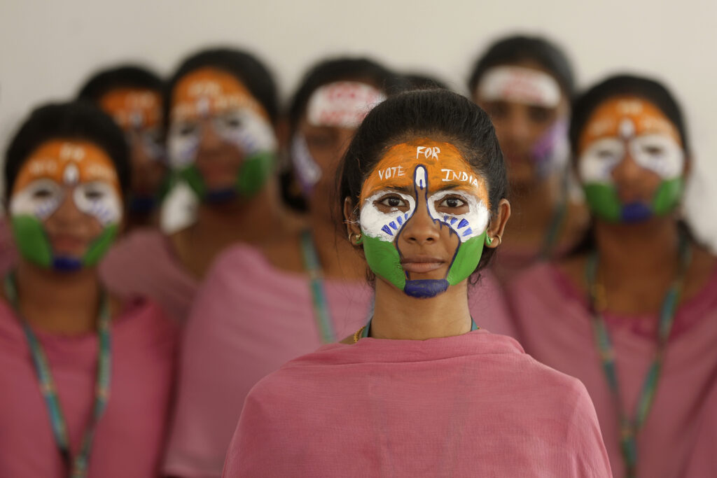 INDIA — Citizens here DO know how to use brightly colored powders and paints: School teachers with the colors of the Indian national flag painted on their faces participate in an event to raise awareness among people to vote in the upcoming general elections in Chennai, India, Thursday, March 28, 2024.Photo: R. Parthibhan/AP