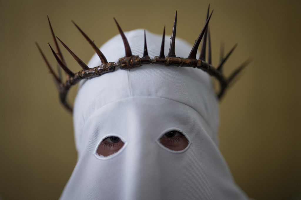 SPAIN — A crown of thorns, menacing garb for a religious brotherhood: A member of the "Penitencia de los Apóstoles y Discípulos de Jesús" Catholic brotherhood before a Holy Week procession in the southern city of Alcala la Real, Spain, Thursday, March 28, 2024.Photo: Bernat Armangue/AP