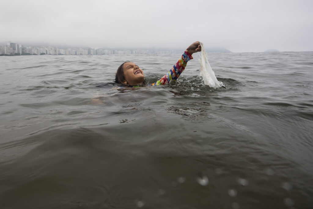 RIO DE JANEIRO — New method of cleaning the ocean involves throwing your kids in it: Nina Gomes collects garbage from the sea near Copacabana beach in Rio de Janeiro, Brazil, Tuesday, March 19, 2024. For years, Gomes has been accompanying her father, Ricardo Gomes, a biologist and director of the Mar Urbano Institute, to collect garbage from the city's beaches and seawater.Photo: Bruna Prado/AP