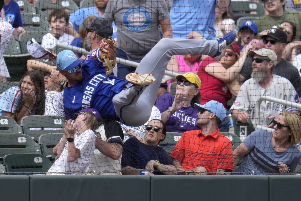 SCOTTSDALE — Front row seats cost extra for this kind of player contact: Kansas City Royals third baseman Nick Loftin crashes into the netting and the first row of fans as he failed to make a play on a foul ball hit by Colorado Rockies' Nolan Jones during the second inning of a spring training baseball game Tuesday, March 12, 2024, in Scottsdale, AZ.Photo: Ross D. Franklin/AP