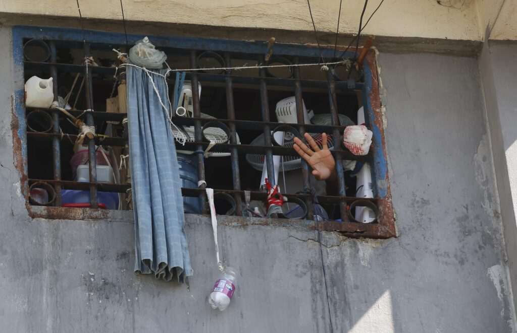 PORT-AU-PRINCE — It’s the only guy left locked up: An inmate waves at the National Penitentiary in Port-au-Prince, Haiti, Sunday, March 3, 2024. Hundreds of inmates have fled Haiti's main prison after armed gangs stormed the facility overnight.Photo: Odelyn Joseph/AP