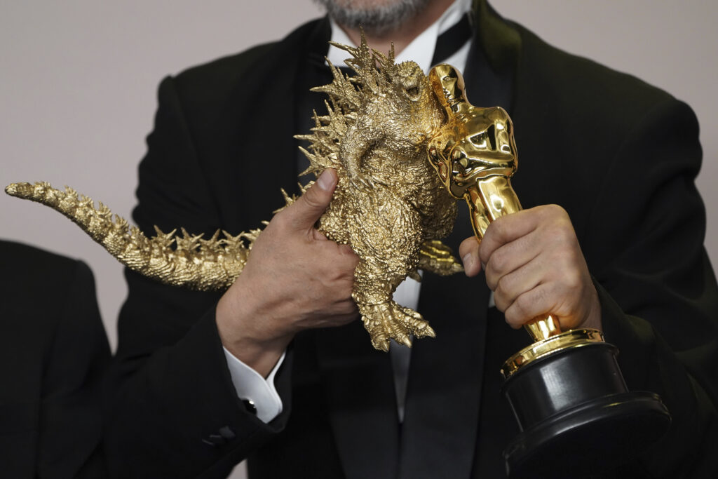 LOS ANGELES — If they lost, they would have had to melt him down: Takashi Yamazaki poses a Godzilla figurine with the award for best visual effects for "Godzilla Minus One" at the Oscars on Sunday, March 10, 2024, at the Dolby Theatre in Los Angeles.Photo: Jordan Strauss/Invision/AP
