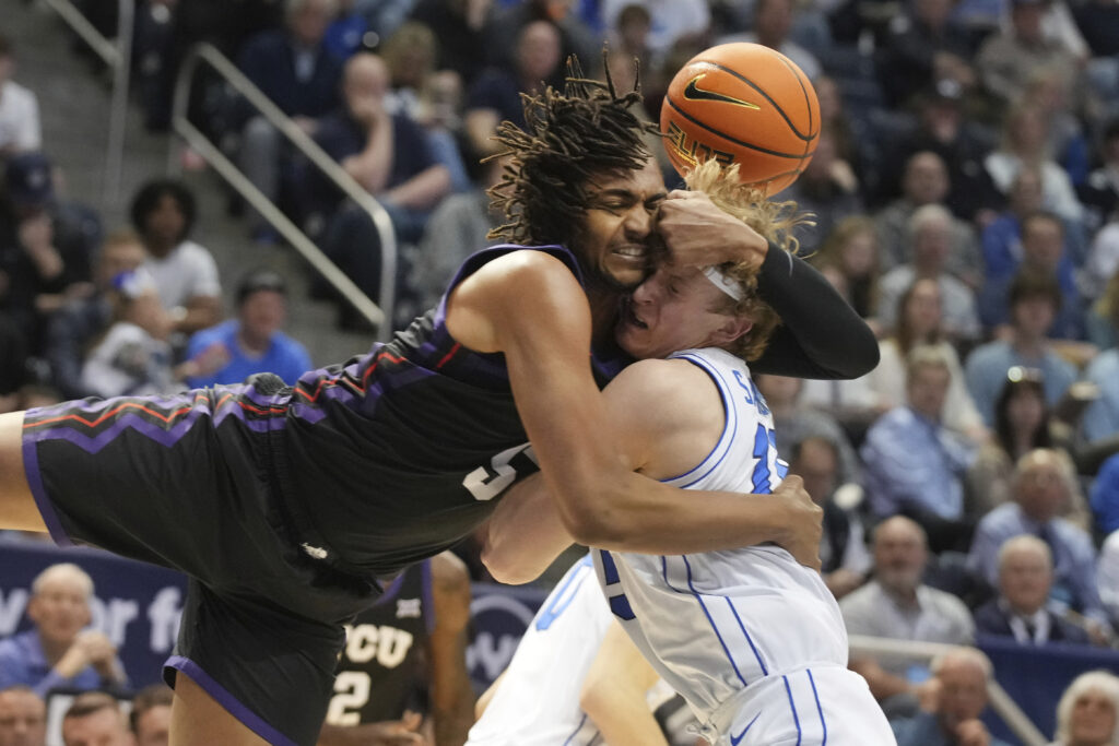 UTAH — They were both going after the ball, but they got each other instead: TCU forward Chuck O'Bannon Jr. (5) and BYU guard Richie Saunders (15) fight for a loose ball during the first half of an NCAA college basketball game Saturday, March 2, 2024, in Provo, Utah.Photo: George Frey/AP