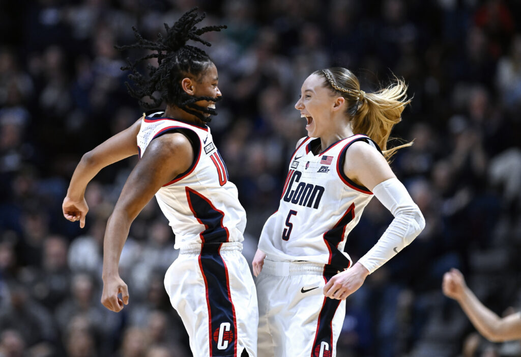 CONNECTICUT — ‘Let’s do a chest bump… okay, just hips!’: UConn guards KK Arnold, left, and Paige Bueckers, right, celebrate during the first half of an NCAA college basketball game against Georgetown in the finals of the Big East Conference tournament at Mohegan Sun Arena, Monday, March 11, 2024, in Uncasville, CT.Photo: Jessica Hill/AP