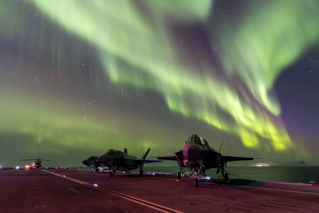 NORWAY — Pretty lights in the sky as a historically neutral power prepares for a Russian attack: In this photo provided by Britain's Ministry of Defense, on Monday, March 4, 2024, F-35B Lightning jets are parked at a flight deck of HMS Prince of Wales aircraft carrier of the Royal Navy, under the northern lights (Aurora Borealis) near the coast of Norway, Sunday, March 3, 2024.Photo: UK Ministry of Defence via AP