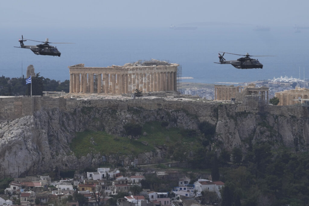 ATHENS — Bridging the centuries on national holiday: Greek military helicopters fly in front of the Acropolis hill during a military parade commemorating Greek Independence Day in Athens on Monday, March 25, 2024. The national holiday on March 25 marks the start of Greece's 1821 war of independence against the 400-year Ottoman rule.Photo: Petros Giannakouris/AP