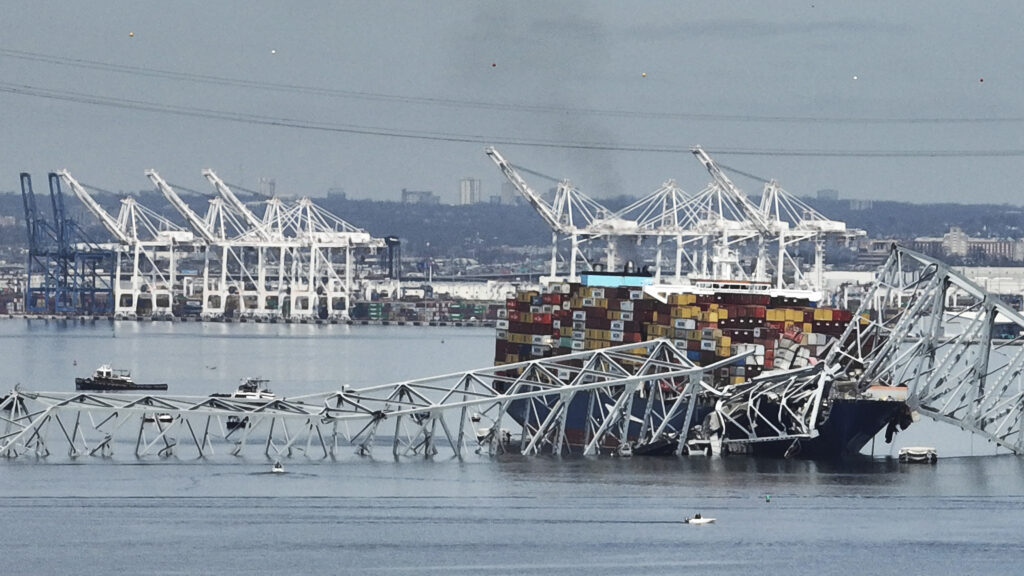 BALTIMORE — Long-term heartache and yet-to-be-measured economic impact: A cargo ship is stuck under part of the structure of the Francis Scott Key Bridge after the ship hit the bridge Tuesday, March 26, 2024, in Baltimore, MD.Photo: Steve Helber/AP