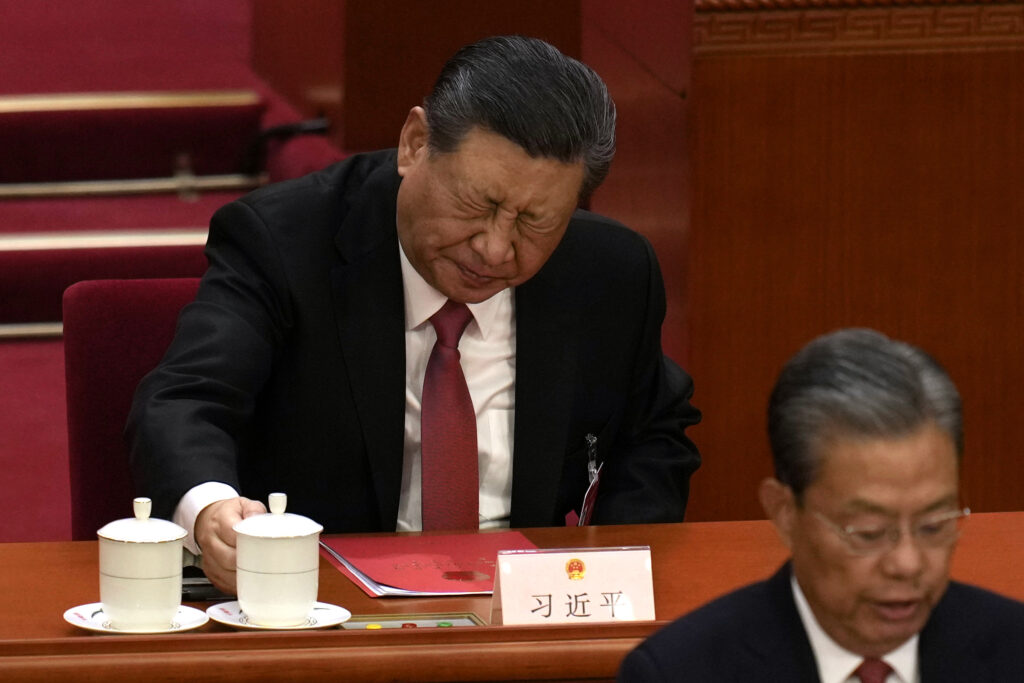 BEIJING — ‘Should have had my assistant try this first…’: Chinese President Xi Jinping, rear, reacts after drinking from a cup at the closing session of the National People's Congress held at the Great Hall of the People in Beijing, Monday, March 11, 2024.Photo: Ng Han Guan/AP