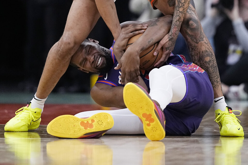 SAN ANTONIO — Just basketball? No, it’s the attack of the tats: Phoenix Suns forward Kevin Durant, bottom, fights for a loose ball with San Antonio Spurs forward Jeremy Sochan during the second half of an NBA basketball game in San Antonio, Monday, March 25, 2024.Photo: Eric Gay/AP