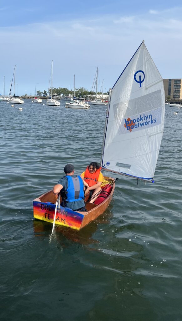 Miramar Yacht Club recently partnered with Brooklyn Boatworks, a nonprofit organization based in DUMBO that provides hands-on STEM (Science, Technology, Engineering, and Math) education for children via the construction of wooden sailboats. Here, Caylee Cardona, 11, takes the “Dream Team” out on her maiden voyage.