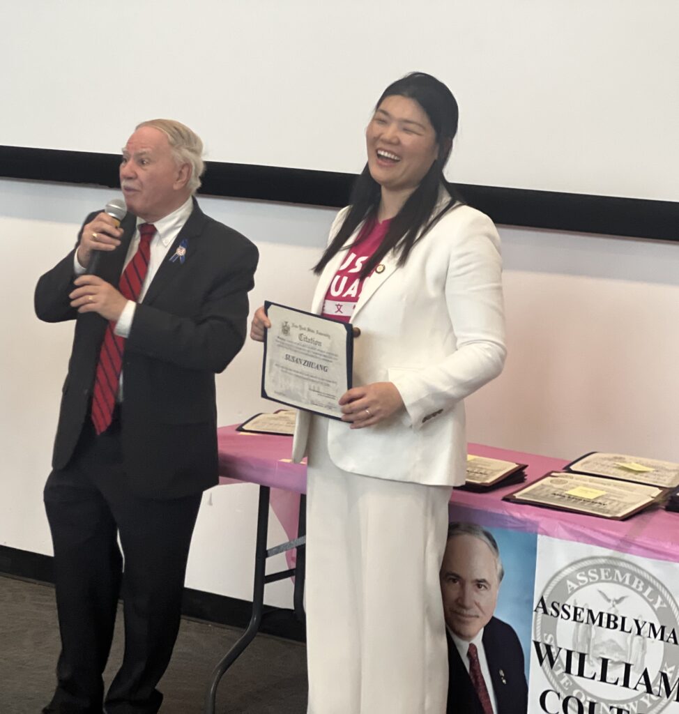 Assemblyman William Colton presenting Councilmember Susan Zhuang (D-43, representing Bensonhurst, Bath Beach, Gravesend, Dyker Heights, Boro Park and Sunset Park) with her citation at Women of Distinction.