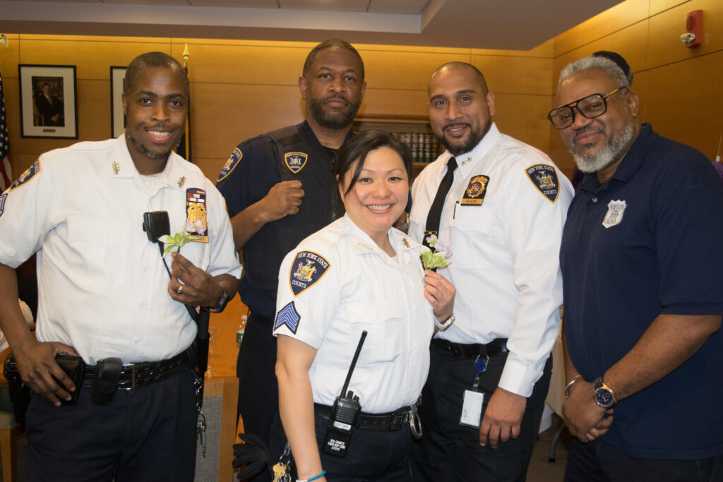 The court officers share in the celebration too. Pictured from left: Sgt. Shaqwan Gardner, Louis Henry, Sgt. Mary Mido Wu, Chief David Salazar and Kevin Carter at SJDEJC Women's History Month.