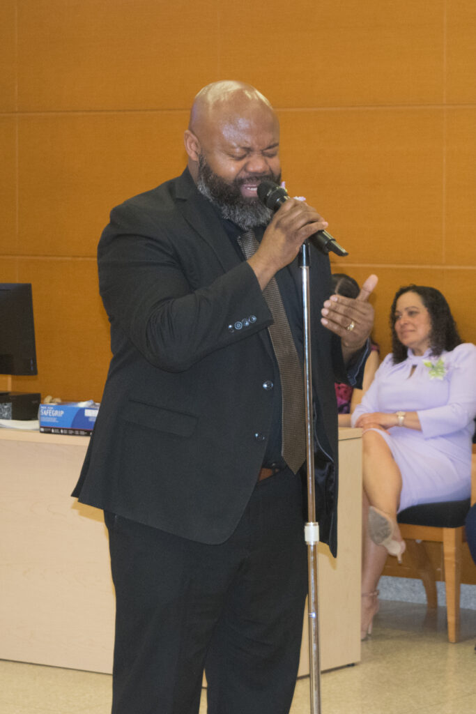 Terrell Lane, a court analyst, delivers a heartfelt song performance, adding a touch of artistic expression to the celebration of Women's History Month at SJDEJC Women's History Month.