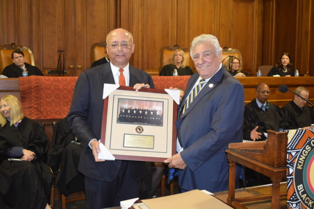 Hon. Frank Seddio, the former chair of the Kings County Democratic Party, stands in to accept the Hon. William Thompson Award from the late judge's son Bill Thompson, Jr., on behalf of U.S. Rep. Hakeem Jeffries.