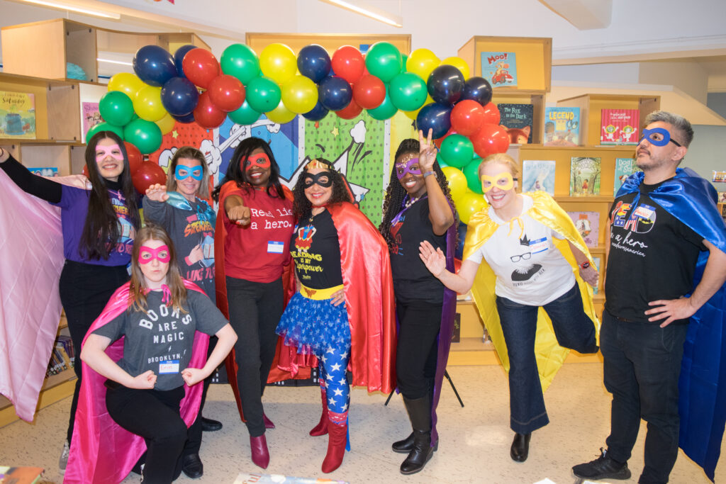 Superheroes of the Legal World: From left to right, Kimberly Oliver-Castro, Erin Peake, Carrie Anne Cavallo, Hon. Genine Edwards, Hon. Joanne Quinones, Hon. Betsey Jean-Jacques, Deborah Johnson and Francisco Manriquez Olivares strike heroic poses at P.S. 274's Read Across America event.Brooklyn Eagle photos by Robert Abruzzese