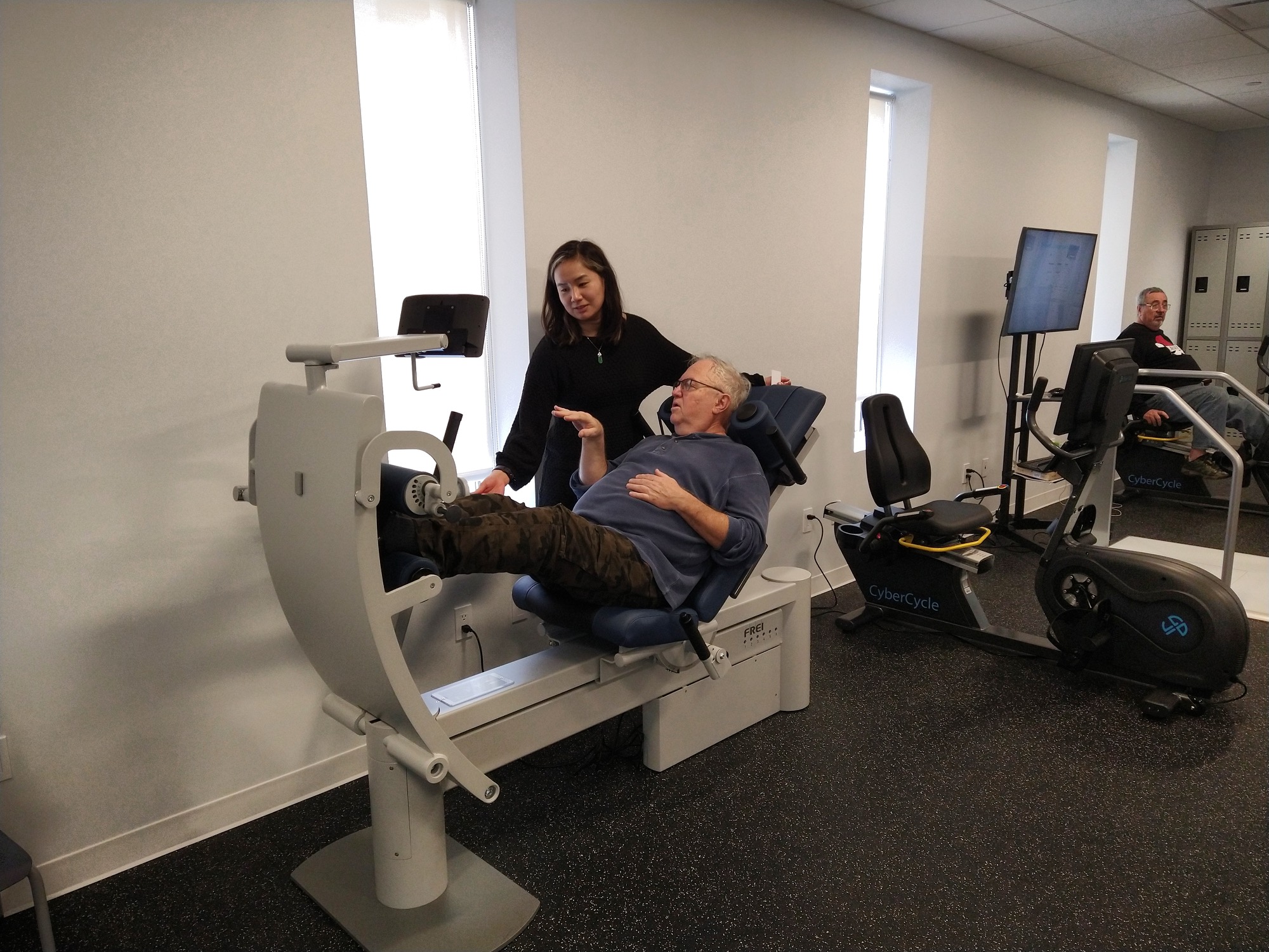 Fiona Ho, health and wellness coordinator, helping a member get the blood flowing in the strength training gym at Bay Ridge Center Opening.