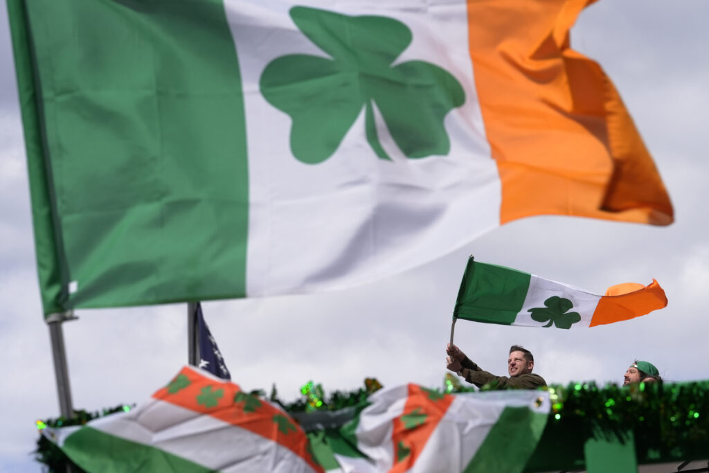 BOSTON — All of the English-speaking world salutes the shamrock: A person waves an Irish flag while watching the St. Patrick's Day parade, Sunday, March 17, 2024, in Boston's South Boston neighborhood.Photo: Steven Senne/AP