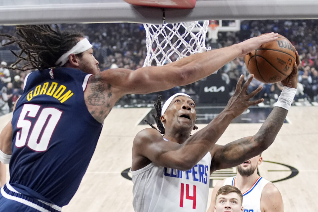 Los Angeles Clippers guard Terance Mann, right, shoots as Denver Nuggets forward Aaron Gordon defends during the first half of an NBA basketball game Thursday, April 4, 2024, in Los Angeles. (AP Photo/Mark J. Terrill)