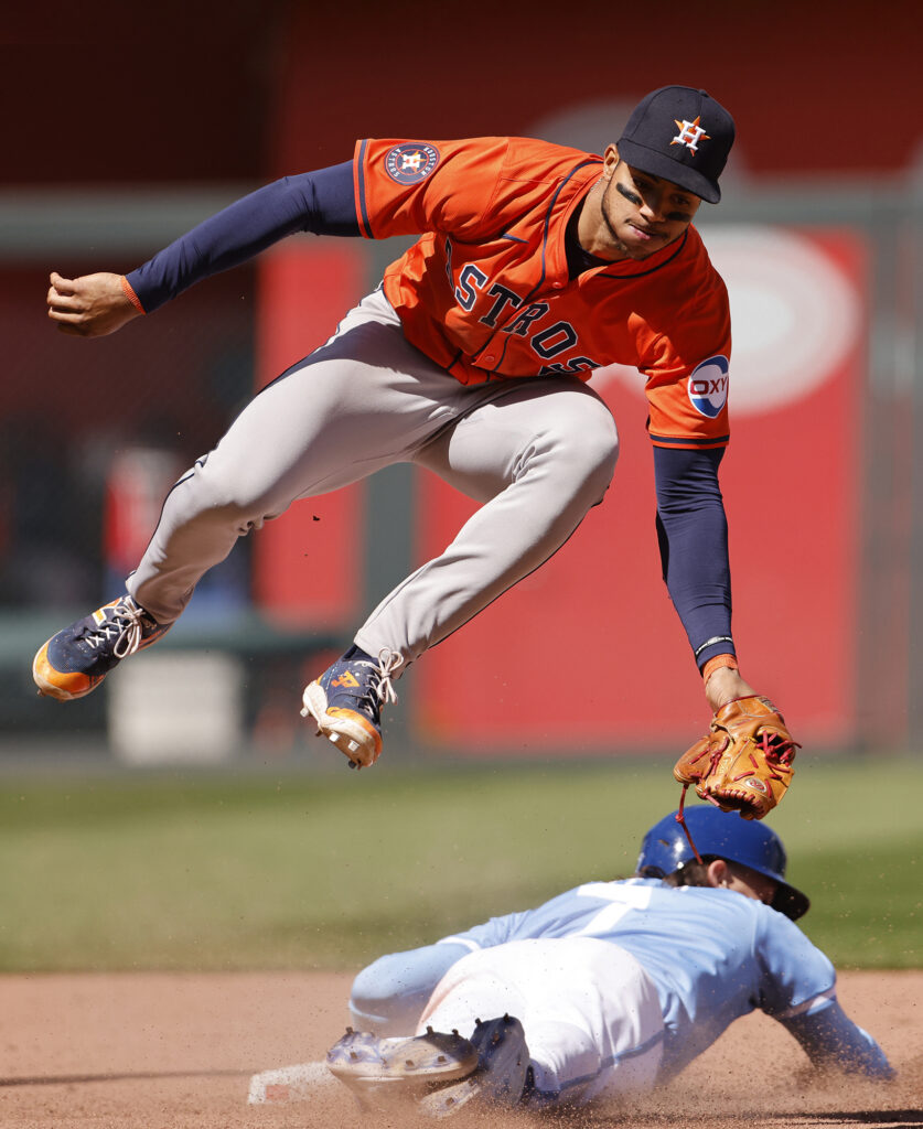 Houston Astros shortstop Jeremy Peña, top, is unable to tag out Kansas City Royals' Bobby Witt Jr. who steals second base during the sixth inning of a baseball game in Kansas City, Mo., Thursday, April 11, 2024. (AP Photo/Colin E. Braley)