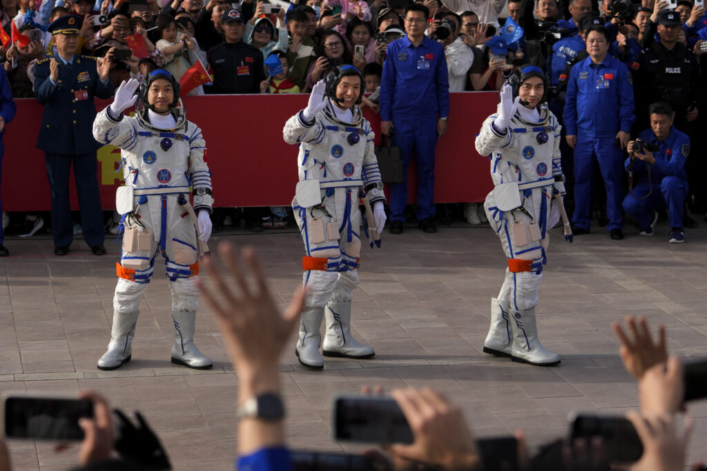 Chinese astronauts for the Shenzhou-18 mission, from right, Ye Guangfu, Li Cong, and Li Guangsu wave as they attend a send-off ceremony for their manned space mission at the Jiuquan Satellite Launch Center in northwestern China, Thursday, April 25, 2024. (AP Photo/Andy Wong)