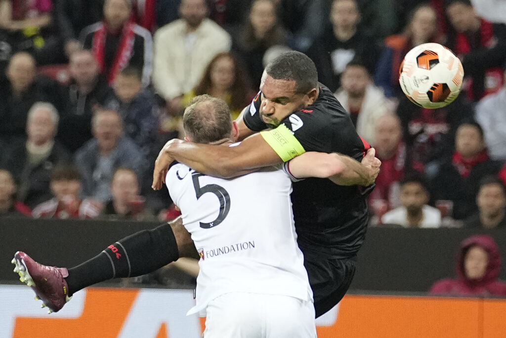 West Ham's Vladimir Coufal, left, and Leverkusen's Jonathan Tah collide as they battle for the ball during the Europa League quarterfinals first-leg soccer match between Bayer 04 Leverkusen and West Ham United at the BayArena in Leverkusen, Germany, Thursday, April 11, 2024. (AP Photo/Martin Meissner)
