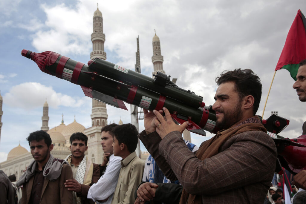 A Houthi supporter holds a mock missile during a protest marking Jerusalem Day in support of Palestinians in the Gaza Strip, in Sanaa, Yemen, Friday, April 5, 2024. (AP Photo/Osamah Abdulrahman)