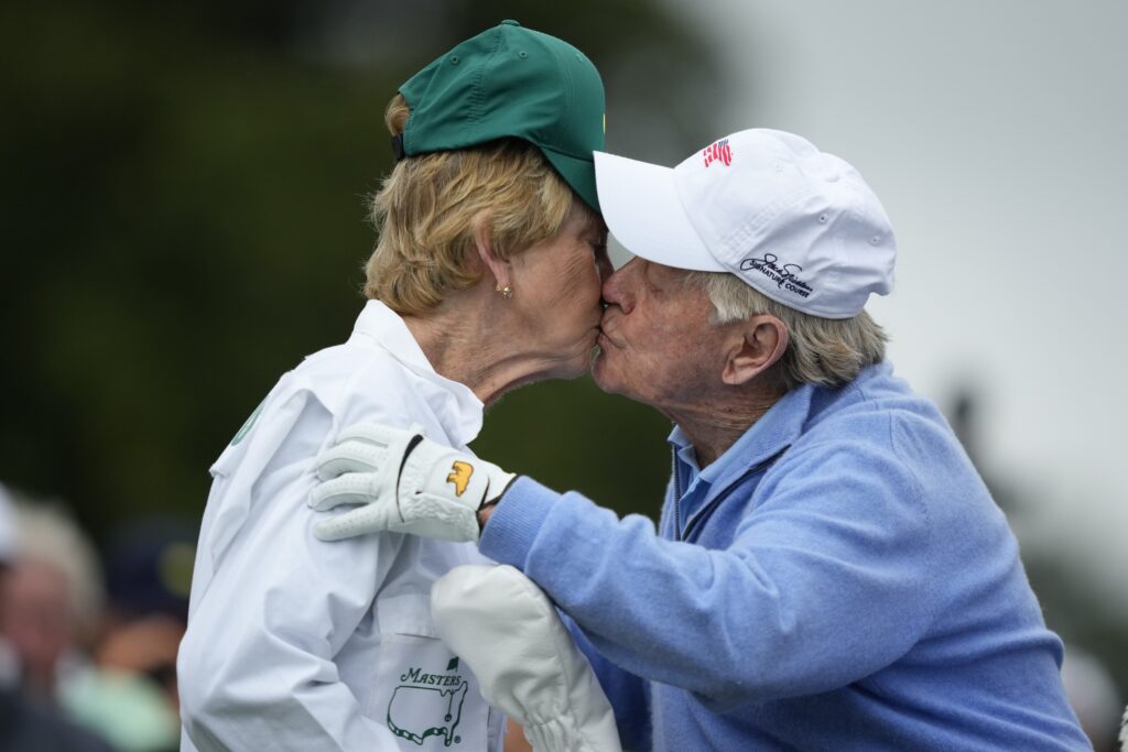 Honorary starter Jack Nicklaus kisses his wife Barbara after the ceremonial tee shot on the first hole during the first round at the Masters golf tournament at Augusta National Golf Club Thursday, April 11, 2024, in Augusta, Ga. (AP Photo/Matt Slocum)