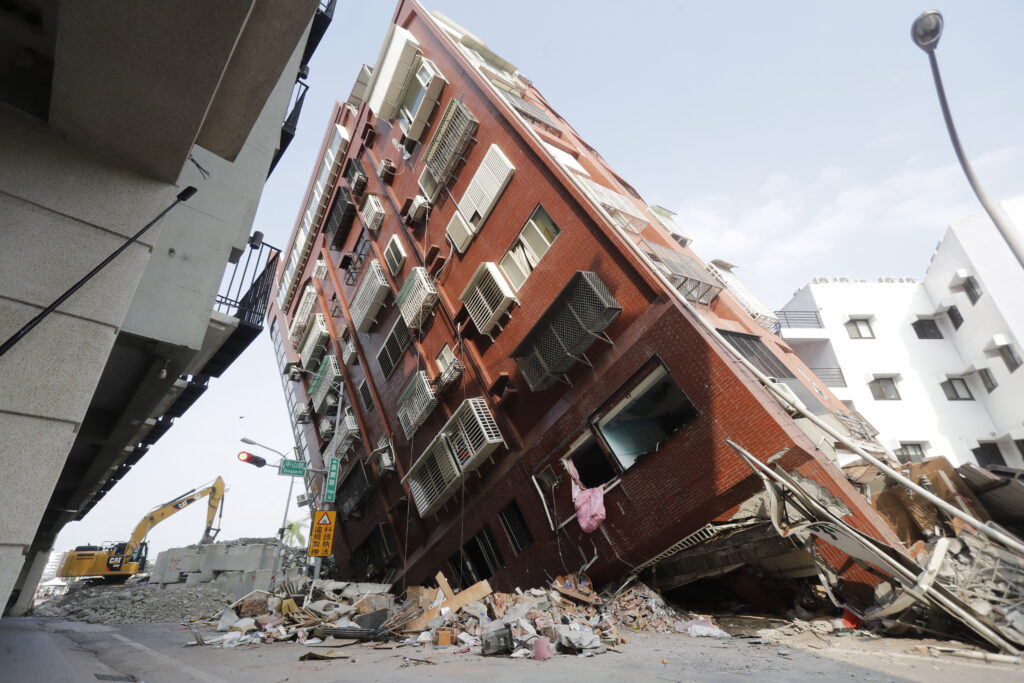 Debris surrounds a titled building a day after a powerful earthquake struck, in Hualien City, eastern Taiwan, Thursday, April 4, 2024. (AP Photo/Chiang Ying-ying)