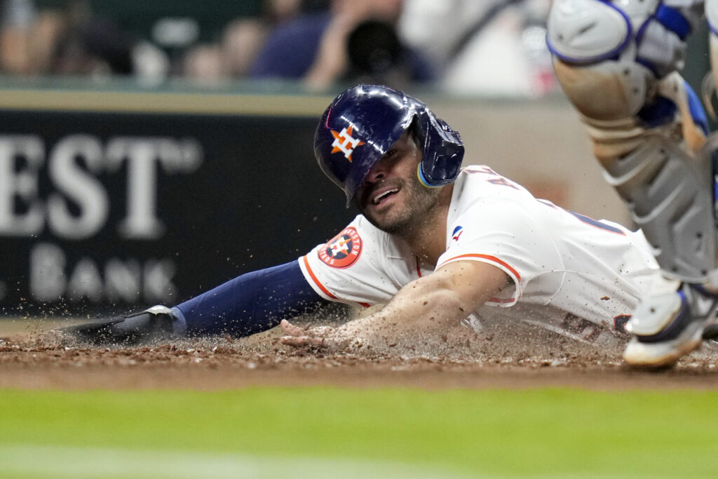 Houston Astros' Jose Altuve scores against the Toronto Blue Jays during the fourth inning of a baseball game Wednesday, April 3, 2024, in Houston. (AP Photo/Eric Christian Smith)