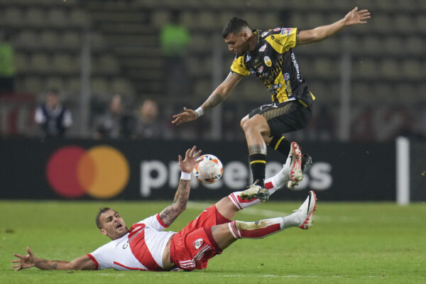 VENEZUELA — ‘Careful where you land, buster…’: Bryan Castillo of Venezuela’s Deportivo Tachira jumps over Leandro Gonzalez Pirez of Argentina’s River Plate during a Copa Libertadores Group H soccer match at Polideportivo de Pueblo Nuevo stadium in San Cristobal, Venezuela, Tuesday, April 2, 2024. The games run through November when the final takes place.The winner will qualify for the 2024 and 2025 FIFA World Cup competitions.Photo: Matias Delacroix/AP