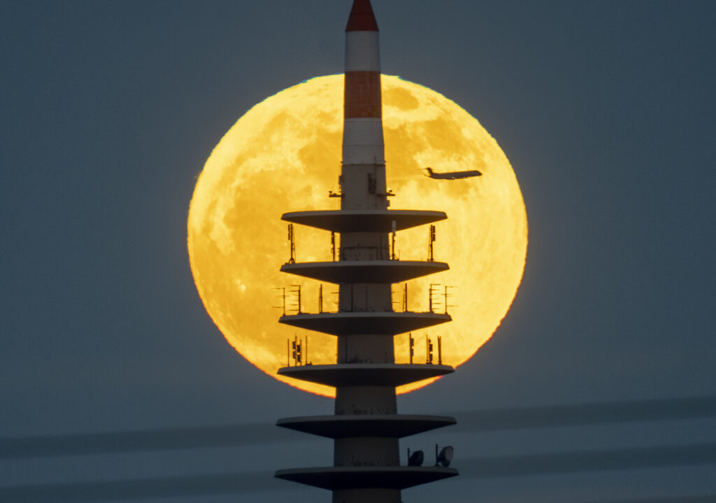 The moon rises behind the television tower in Frankfurt, Germany, Tuesday, April 23, 2024. (AP Photo/Michael Probst)