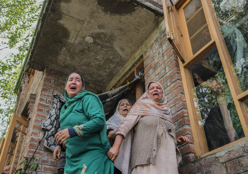 Women weep during a joint funeral of victims of a boat capsize on the outskirts of Srinagar, Indian controlled Kashmir, Tuesday, April. 16, 2024. The boat capsized in Jhelum river, most of the passengers were children, and rescuers were searching for many others who were still missing. (AP Photo/Mukhtar Khan)