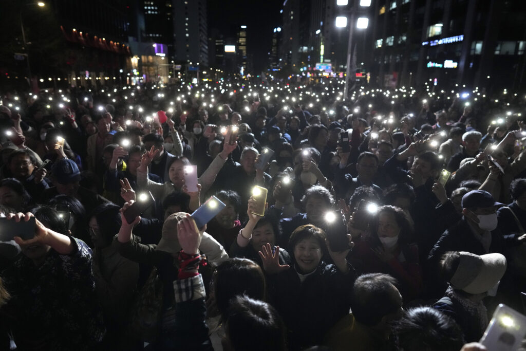 Supporters of South Korea's ruling People Power Party flash their smartphones' lights during the party's parliamentary election campaign in Seoul, South Korea, Tuesday, April 9, 2024. (AP Photo/Lee Jin-man)
