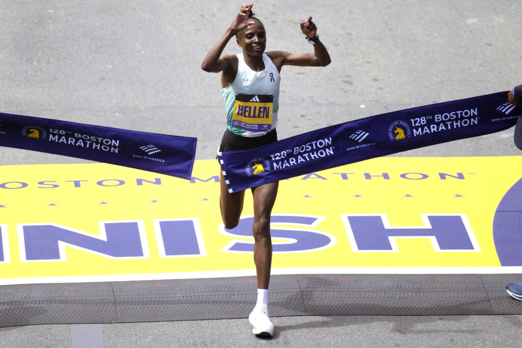 Hellen Obiri, of Kenya, raises her arms as she wins the women's division at the Boston Marathon, Monday, April 15, 2024, in Boston. (AP Photo/Charles Krupa)