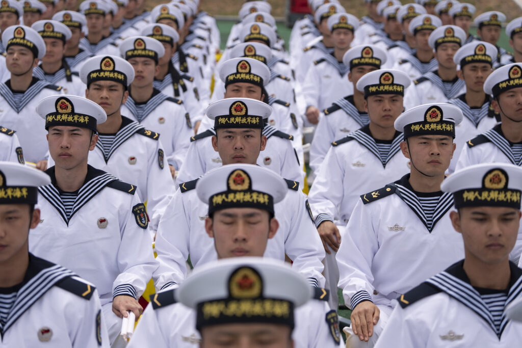 Chinese sailors sit in rows during a tour arranged for foreign journalists, a day before the opening of the West Pacific Naval Symposium in Qingdao in eastern China's Shandong province, Sunday, April 21, 2024. Established in 1953, the Academy has trained more than 100,000 naval officers and sailors for the Chinese navy and over 80 percent of submarine staff graduate or were trained here, according to China's official People's Daily. (AP Photo/Ng Han Guan)