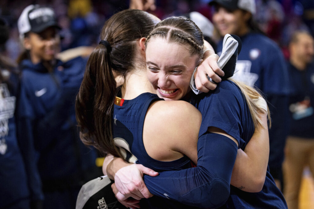 PORTLAND — Ecstasy of March Madness on the hardcourt: UConn guard Paige Bueckers, right, hugs guard Nika Muhl after their win over Southern California in an Elite Eight college basketball game in the women's NCAA Tournament, Monday, April 1, 2024, in Portland, OR.Photo: Howard Lao/AP