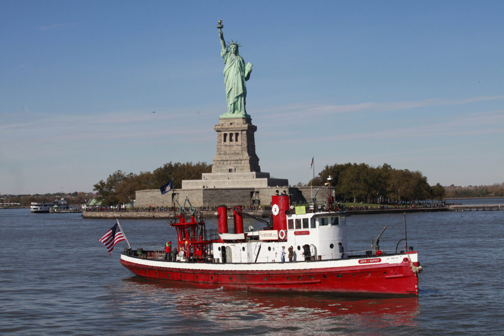 The fireboat John J. Harvey passes the Statue of Liberty, Oct. 28, 2011, in New York Harbor.