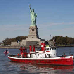 The fireboat John J. Harvey passes the Statue of Liberty, Oct. 28, 2011, in New York Harbor.