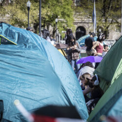 A student protester sits among the tents erected at the pro-Palestinian demonstration encampment at Columbia University in New York, Monday April 22, 2024.