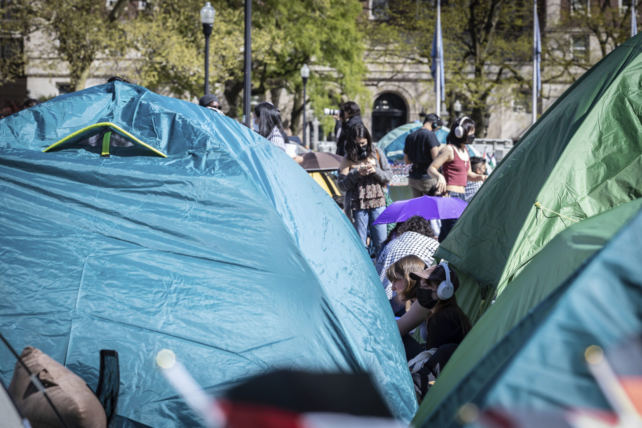A student protester sits among the tents erected at the pro-Palestinian demonstration encampment at Columbia University in New York, Monday April 22, 2024.